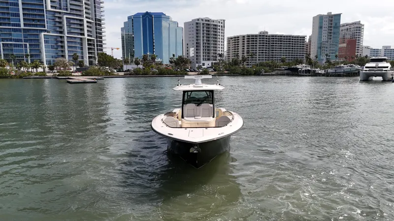 Slide: The Image of 2024 Scout 377 LXF boat on water with city skyline background. - 4