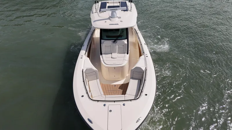 Slide: The Image of 2024 Scout 377 LXF boat cruising on open water, aerial view. - 7