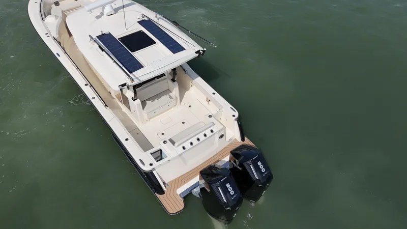 Slide: The Image of 2024 Scout 377 LXF boat with dual engines on calm water. - 8