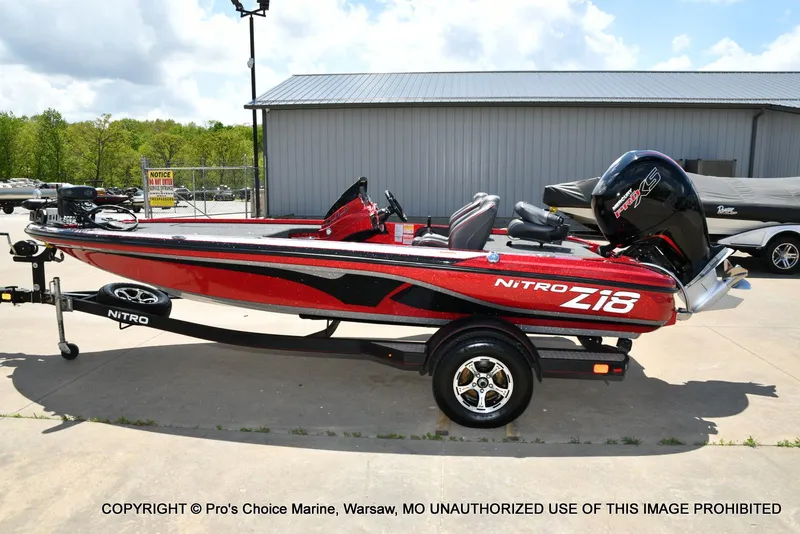 Slide: The Image of 2021 Nitro Z18 boat with 150 Mercury Pro-XS 4 Stroke engine, parked outdoors. - 28