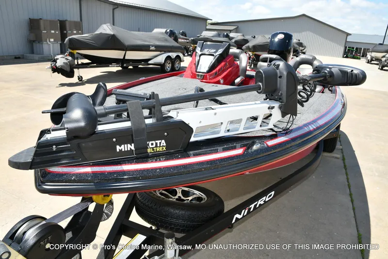 Slide: The Image of 2021 Nitro Z18 boat with Minn Kota Ultrex trolling motor, parked outdoors. - 30