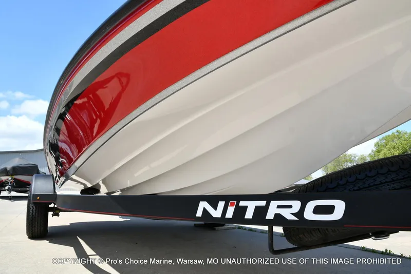 Slide: The Image of 2021 Nitro Z18 boat on trailer, featuring sleek red and white design. - 33