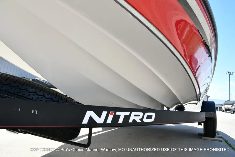 Slide: The Image of 2021 Nitro Z18 boat on trailer, showcasing sleek red and white hull design. - 34