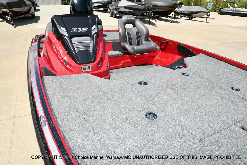 Slide: The Image of 2021 Nitro Z18 boat with Mercury Pro-XS engine, red and gray interior, parked outdoors. - 36