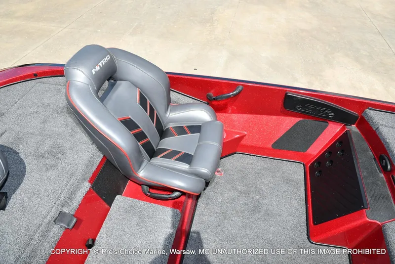Slide: The Image of 2021 Nitro Z18 boat interior with gray and red seating, carpeted flooring. - 48