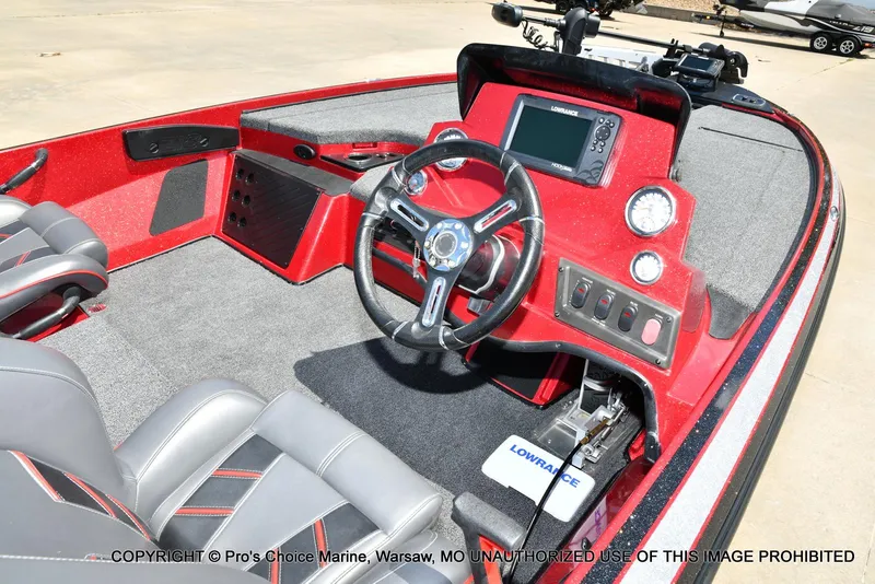 Slide: The Image of 2021 Nitro Z18 boat interior with steering wheel and control panel, featuring red and gray design. - 7