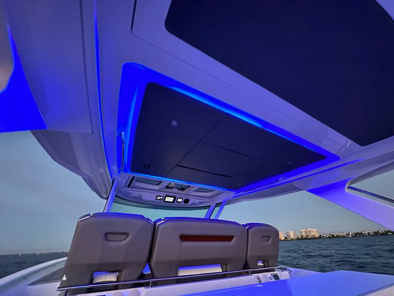 Slide: The Image of 2020 Tiara Yachts 43 LS interior with blue LED lighting, overlooking the ocean. - 25