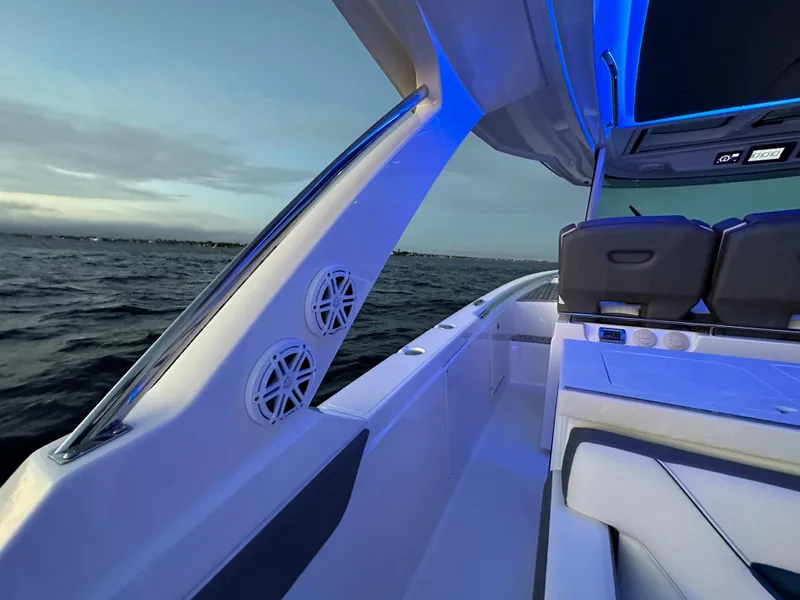Slide: The Image of 2020 Tiara Yachts 43 LS boat interior with blue LED lighting at sunset. - 26