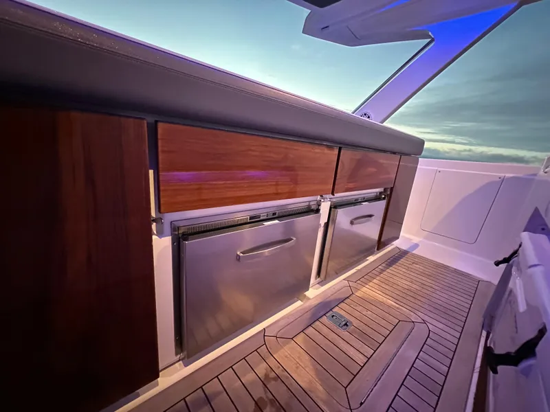 Slide: The Image of 2020 Tiara Yachts 43 LS interior with wooden cabinetry and stainless steel appliances. - 28