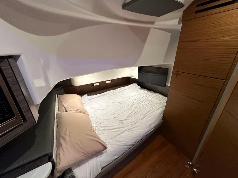 Slide: The Image of 2020 Tiara Yachts 43 LS cabin interior with cozy bed and wooden accents. - 30