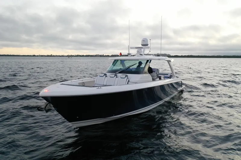 Slide: The Image of 2020 Tiara Yachts 43 LS cruising on open water under cloudy skies. - 4