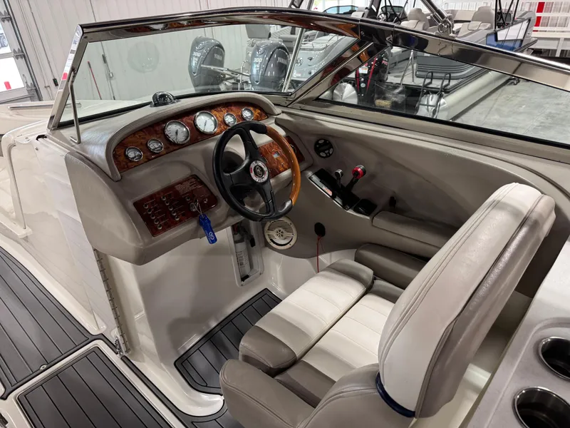 Slide: The Image of 2002 Cobalt 282 BR boat interior with steering wheel and dashboard controls. - 15