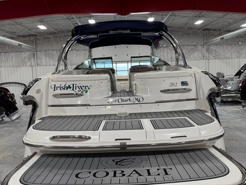 Slide: The Image of 2002 Cobalt 282 BR boat in showroom, featuring sleek design and spacious deck. - 5