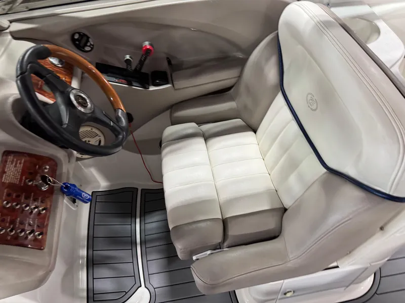 Slide: The Image of 2002 Cobalt 282 BR boat interior with steering wheel and plush captain's seat. - 8