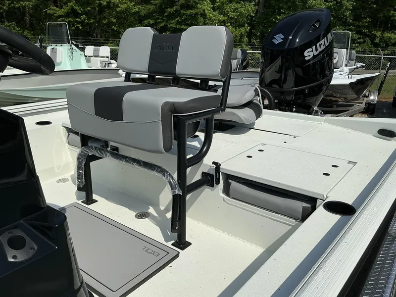 Slide: The Image of 2025 Excel Bay Pro 220 ELITE boat interior with seating and Suzuki outboard motor. - 4