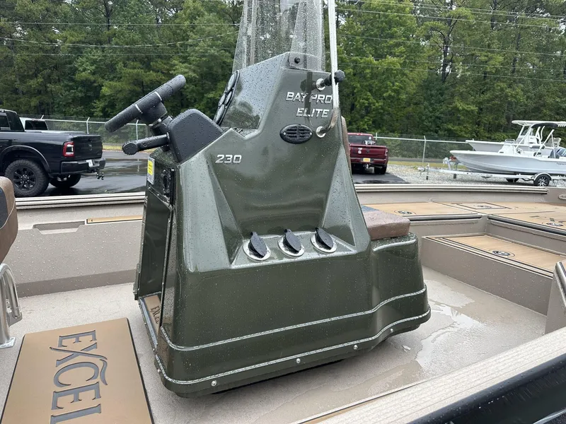 Slide: The Image of 2025 Excel New Bay Pro 230 boat console, wet from rain, in a parking lot. - 3