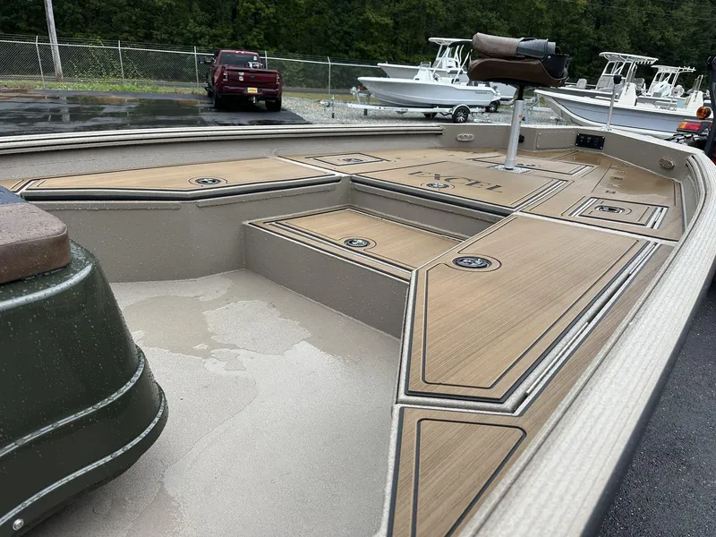 Slide: The Image of 2025 Excel New Bay Pro 230 boat interior with sleek deck design and seating. - 4