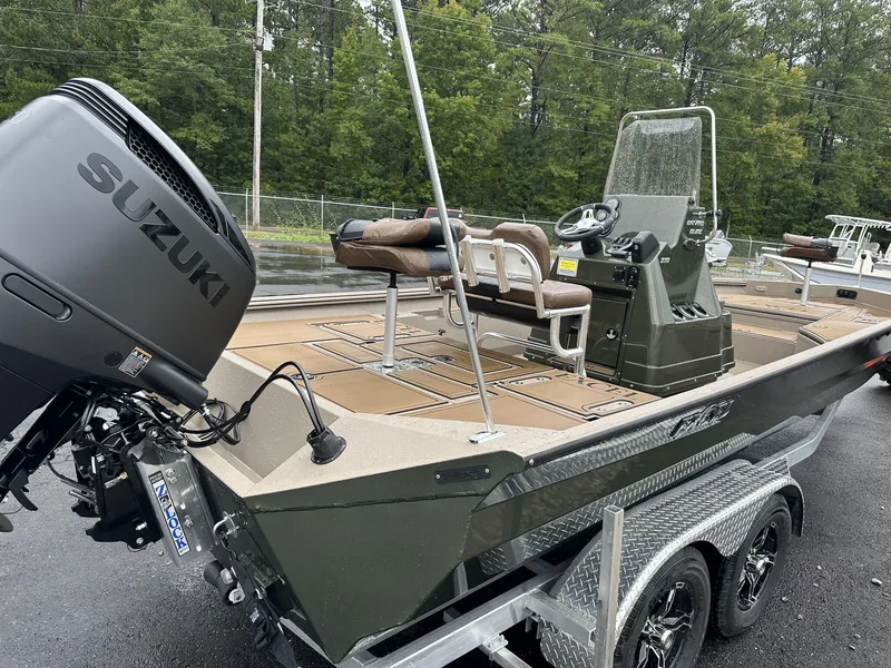 Slide: The Image of 2025 Excel New Bay Pro 230 boat with Suzuki engine, parked on a trailer. - 6