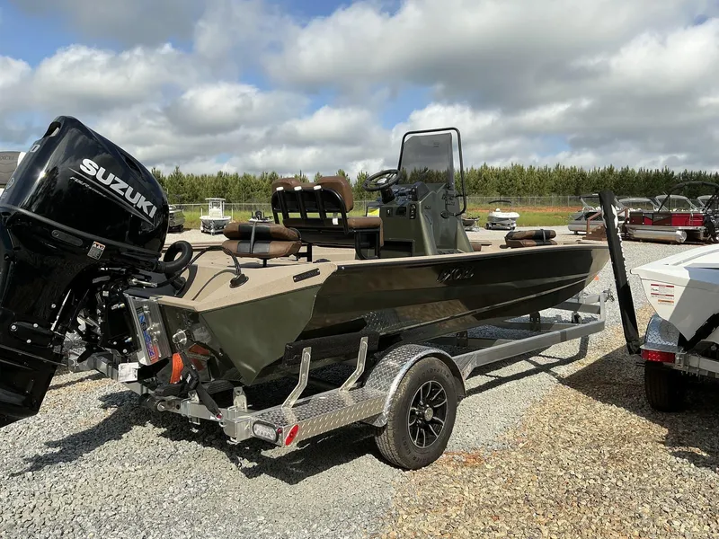 Slide: The Image of 2025 Excel Bay Pro 203 ELITE boat with Suzuki engine on trailer, outdoors. - 10