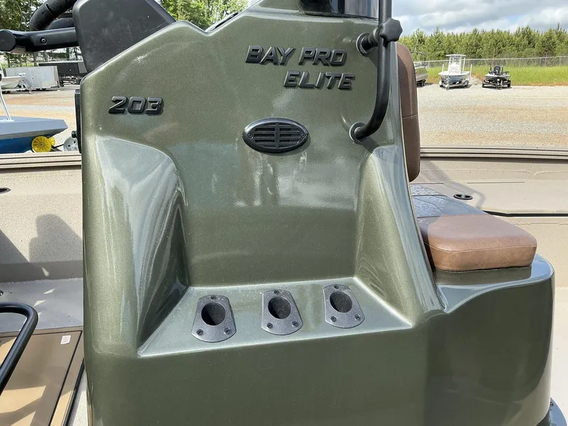 Slide: The Image of 2025 Excel Bay Pro 203 Elite boat console with rod holders and seating. - 3