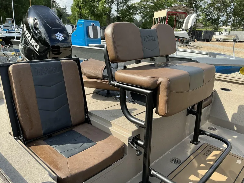Slide: The Image of 2025 Excel Bay Pro 203 ELITE boat seats with Suzuki engine in a marina setting. - 7