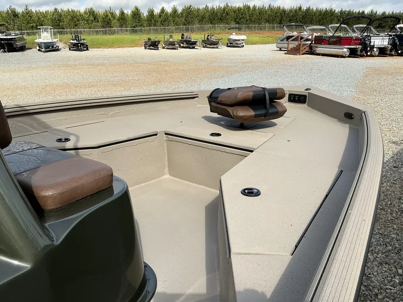 Slide: The Image of 2025 Excel Bay Pro 203 Elite boat with seating, displayed outdoors on gravel. - 4
