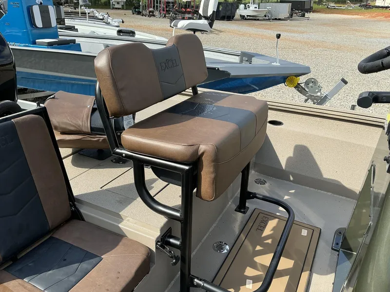 Slide: The Image of 2025 Excel Bay Pro 203 ELITE boat seats, brown and black, in a showroom setting. - 9