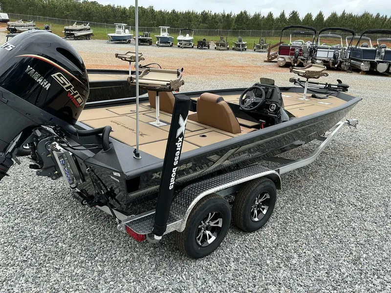 Slide: The Image of 2025 Xpress Hyper-Lift Crappie Series H20 boat on trailer, featuring Yamaha engine. - 11