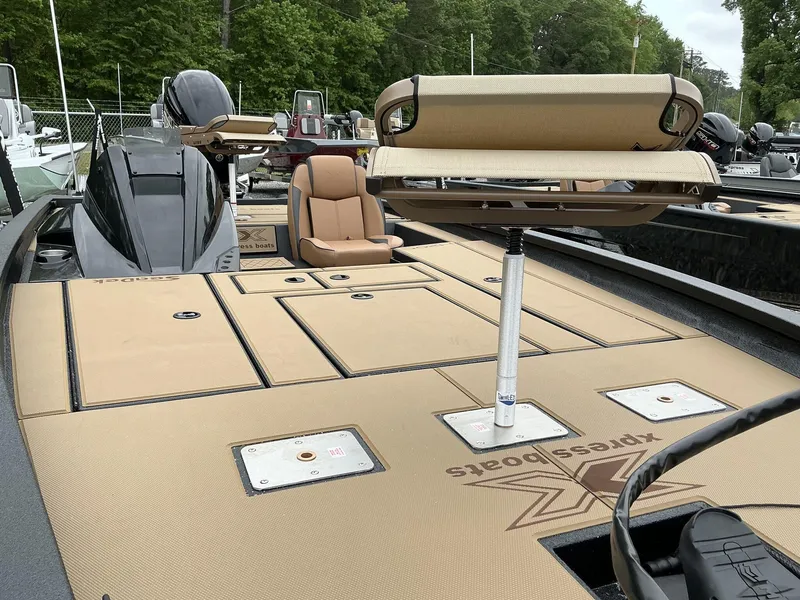 Slide: The Image of 2025 Xpress Hyper-Lift Crappie Series H20 boat with tan seating and storage compartments. - 5