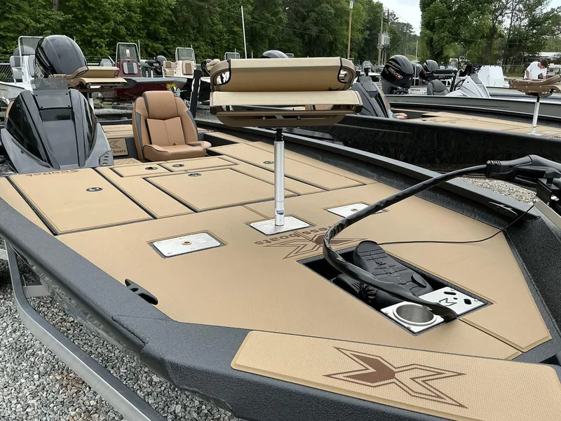 Slide: The Image of 2025 Xpress Hyper-Lift Crappie Series H20 boat with tan deck and seating. - 6