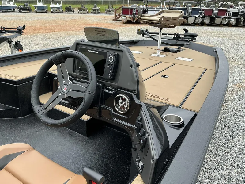 Slide: The Image of 2025 Xpress Hyper-Lift Crappie Series H20 boat interior with steering wheel and control panel. - 8