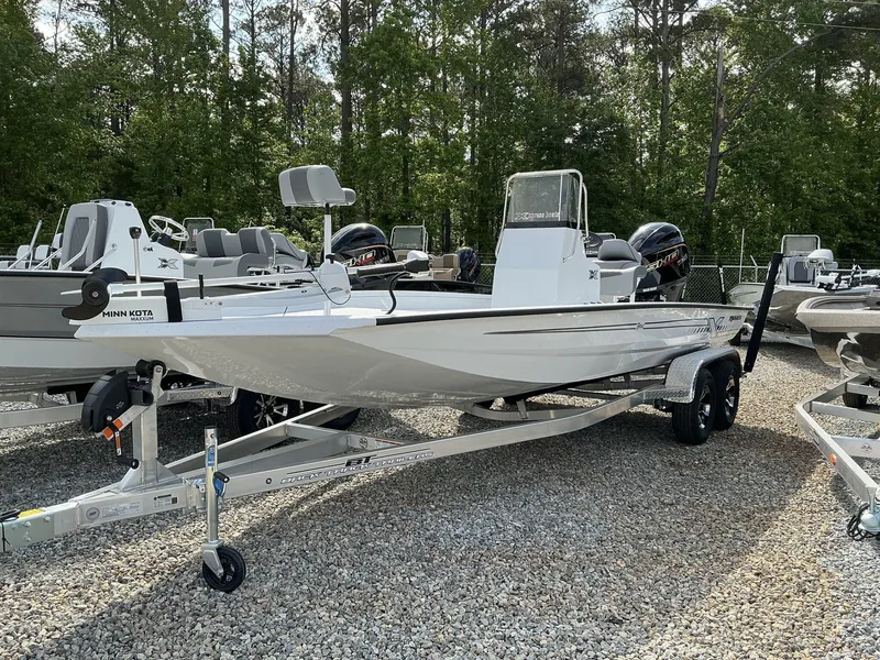 Slide: The Image of 2025 Xpress Hyper-Lift Bay Series 210 BAY-175 HP boat on trailer, outdoors. - 1