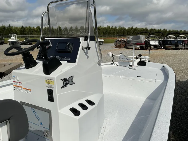 Slide: The Image of 2025 Xpress Hyper-Lift Bay Series 210 BAY-175 HP boat, white interior, steering console, outdoor display. - 12