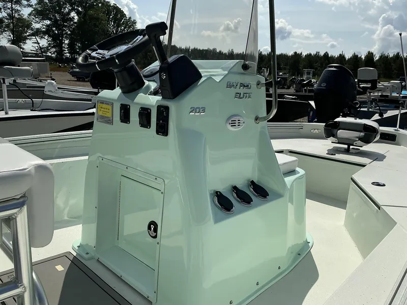Slide: The Image of 2025 Excel Bay Pro 203 Elite boat console with steering wheel and controls. - 5
