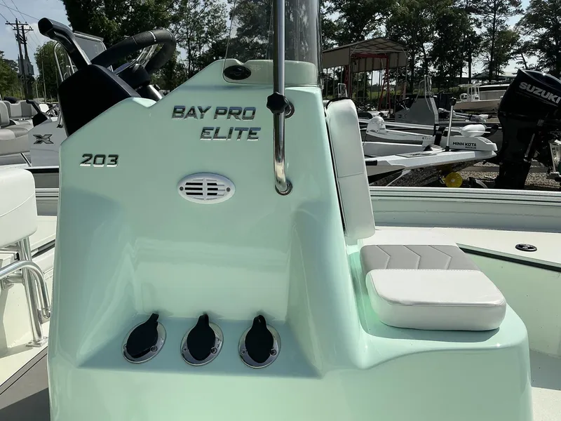 Slide: The Image of 2025 Excel Bay Pro 203 Elite boat console with seating and controls. - 7