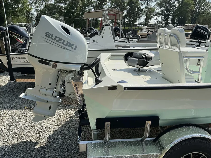 Slide: The Image of 2025 Excel Bay Pro 203 Elite boat with Suzuki outboard motor on trailer. - 8