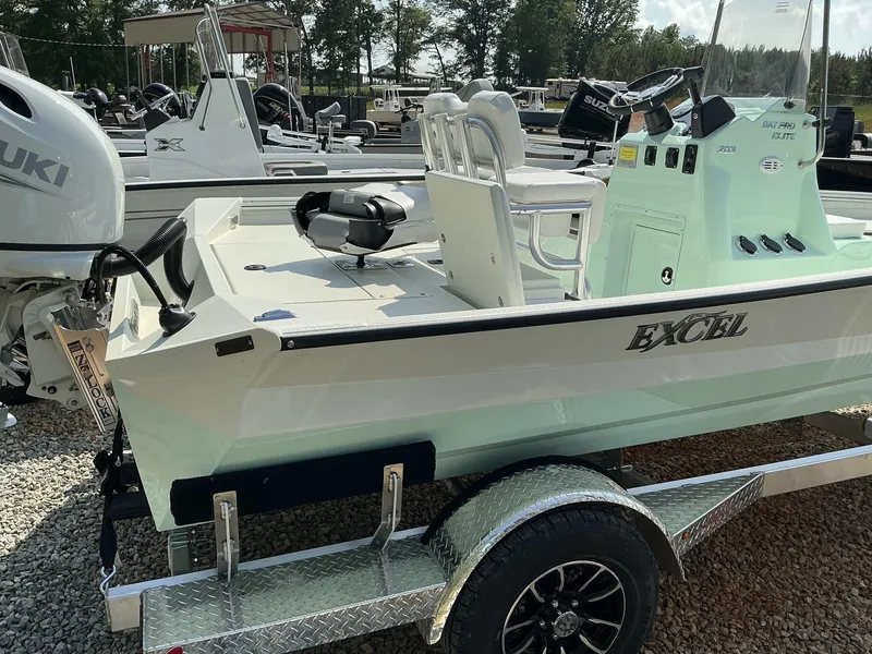 Slide: The Image of 2025 Excel Bay Pro 203 Elite boat on trailer, featuring Suzuki outboard motor. - 9