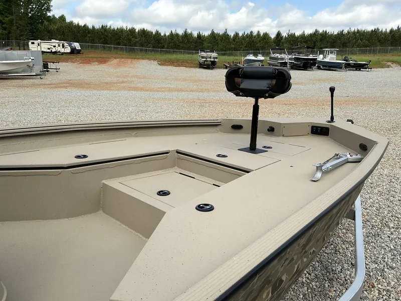 Slide: The Image of 2025 Excel Bay Pro 220 ELITE boat on gravel lot with other boats. - 3