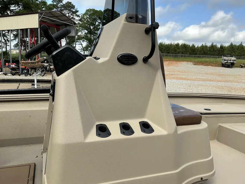 Slide: The Image of 2025 Excel Bay Pro 220 Elite boat console with steering wheel, outdoors. - 6