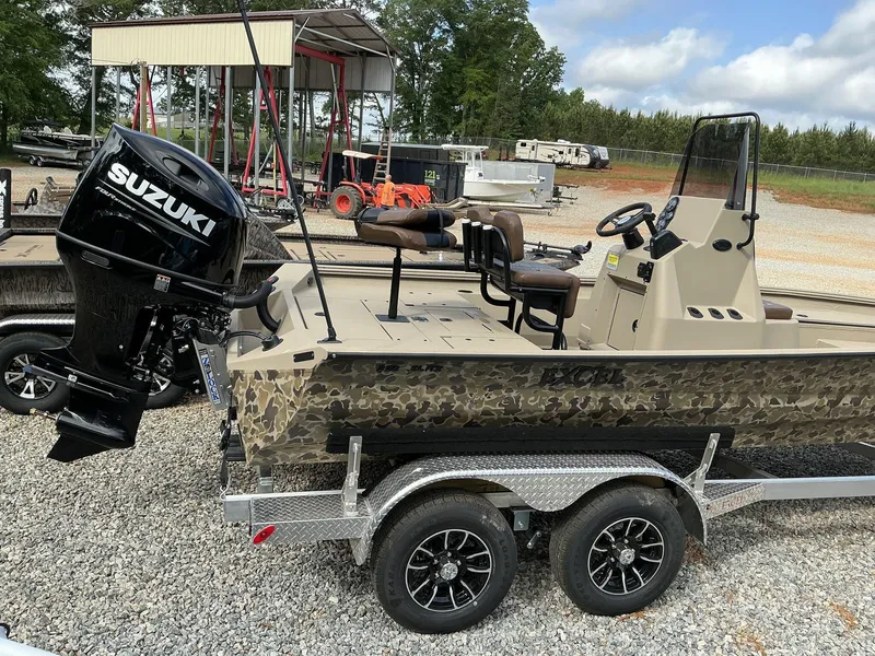 Slide: The Image of 2025 Excel Bay Pro 220 ELITE boat with Suzuki motor on a trailer. - 9