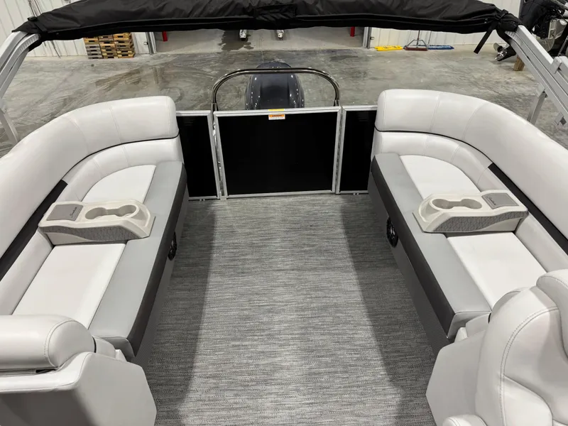Slide: The Image of 2023 Sweetwater 2286 boat interior with gray seating and cup holders. - 12