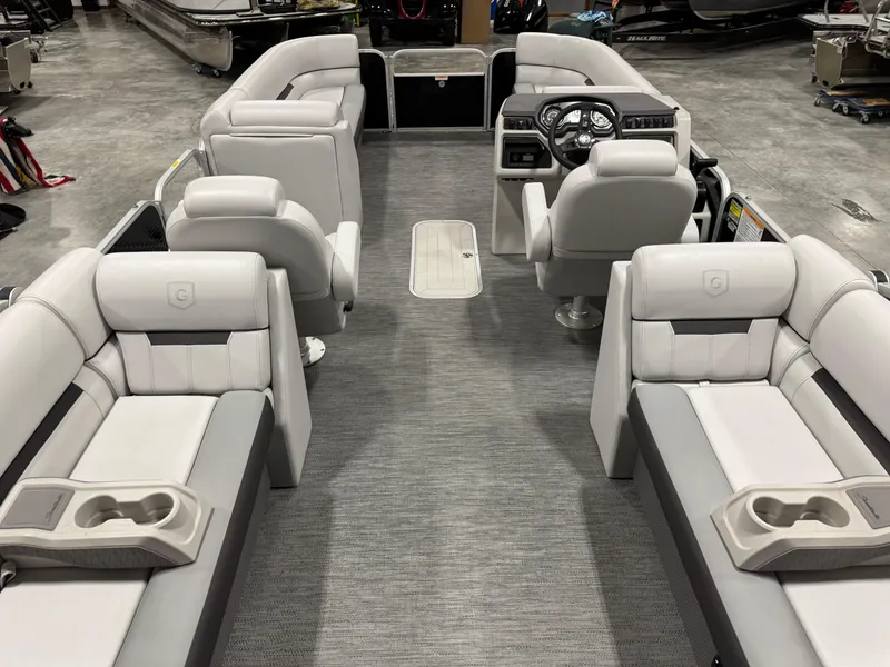 Slide: The Image of 2023 Sweetwater 2286 pontoon boat interior with plush seating and modern helm. - 13