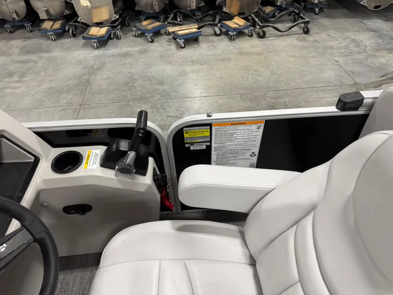 Slide: The Image of 2023 Sweetwater 2286 boat interior with white seating and control panel. - 14