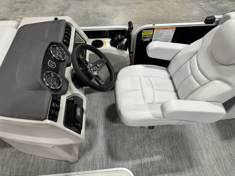Slide: The Image of Captain's seat and dashboard of 2023 Sweetwater 2286 boat, featuring modern controls and plush seating. - 15