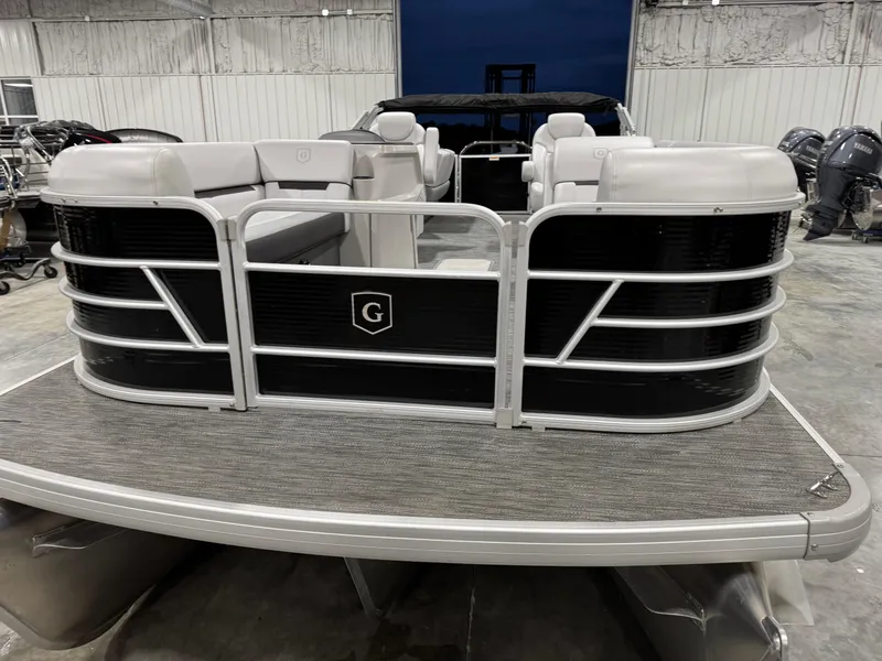 Slide: The Image of 2023 Sweetwater 2286 pontoon boat in a showroom, featuring sleek design and spacious seating. - 4