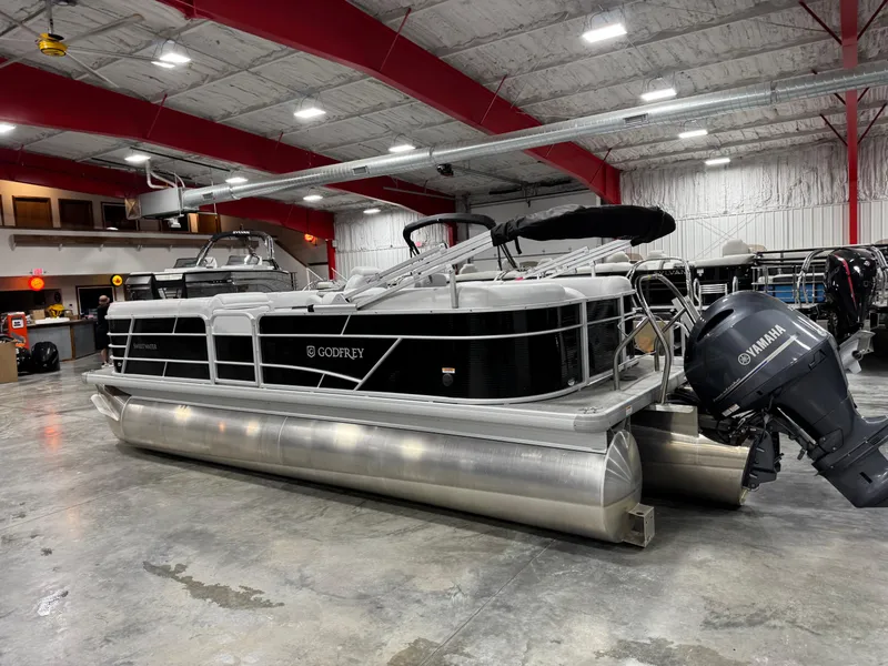 Slide: The Image of 2023 Sweetwater 2286 pontoon boat in showroom with Yamaha outboard motor. - 5