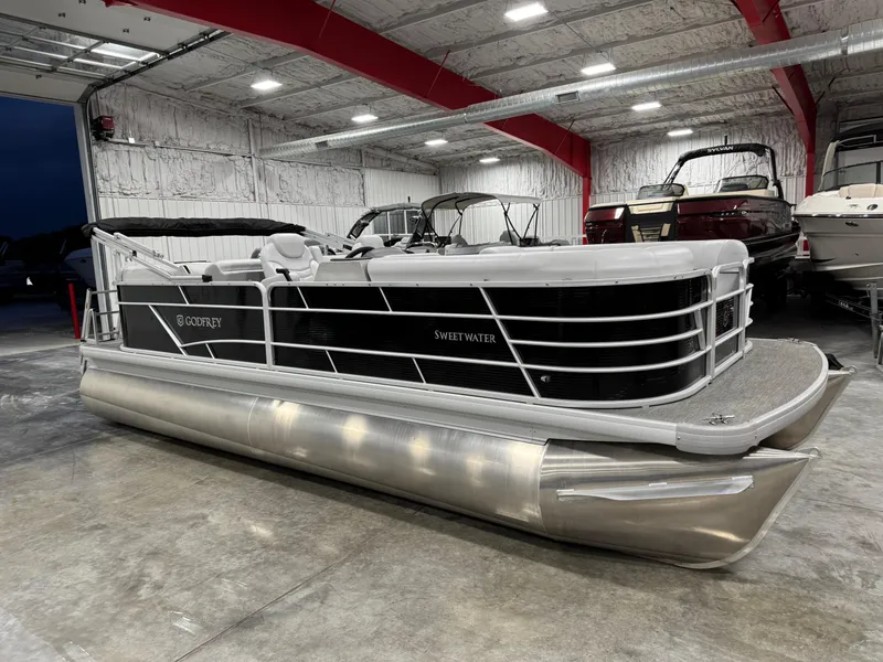 Slide: The Image of 2023 Sweetwater 2286 pontoon boat in a showroom, featuring sleek design and modern amenities. - 8