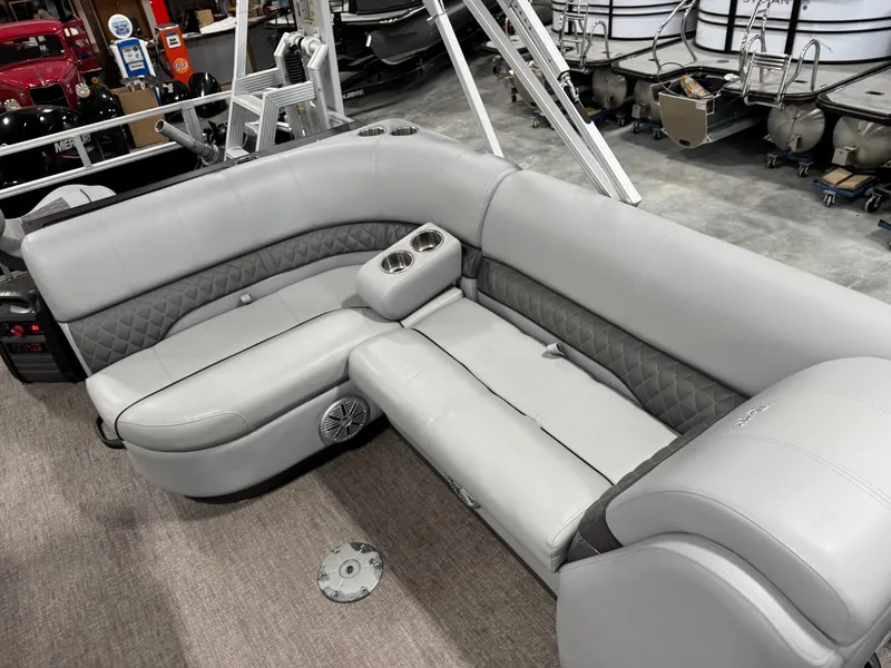 Slide: The Image of Gray seating area on a 2020 Ranger 223 FC boat, featuring cup holders and speaker. - 10