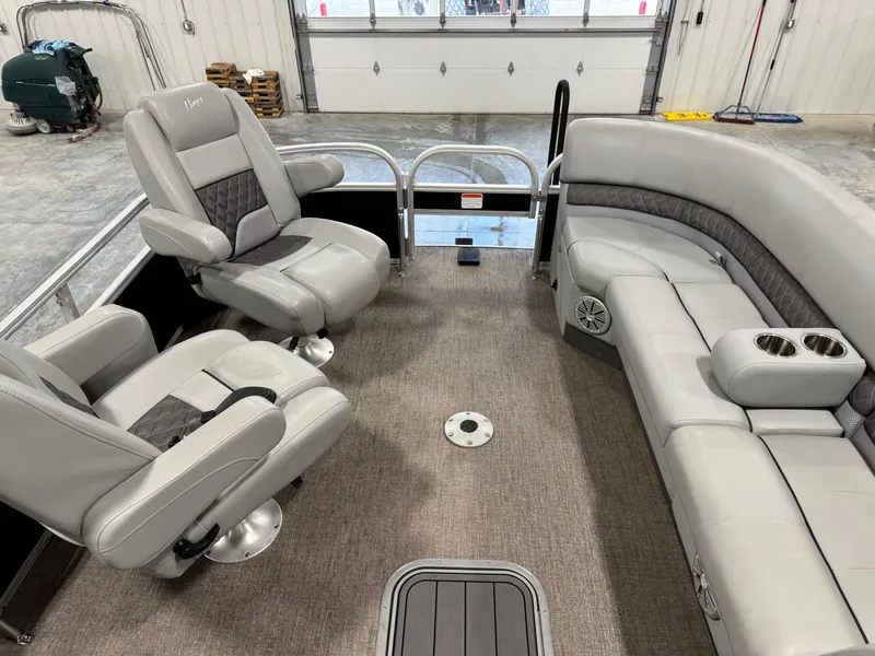 Slide: The Image of 2020 Ranger 223 FC boat interior with gray seating and carpeted floor in a garage. - 11