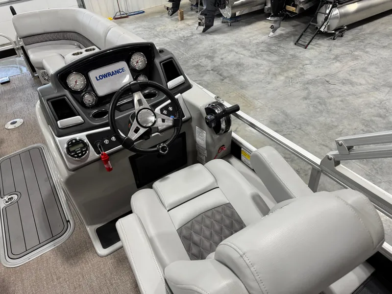 Slide: The Image of 2020 Ranger 223 FC boat cockpit with steering wheel and Lowrance display. - 12